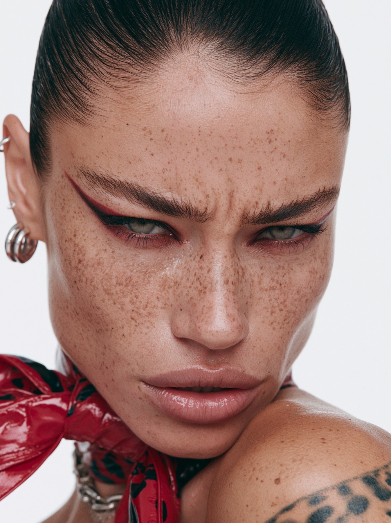 Close beauty portrait with red eye makeup and freckles